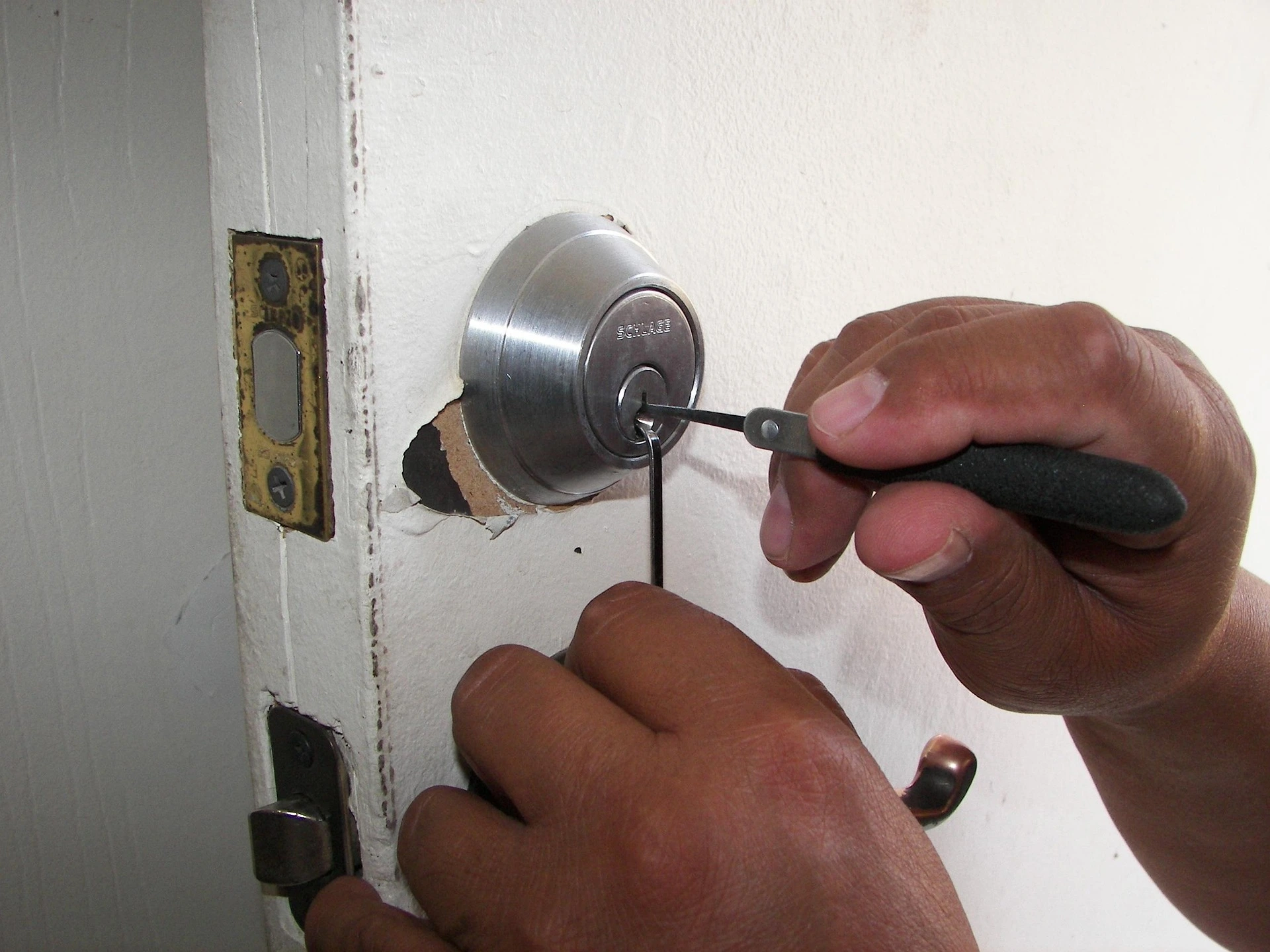 Heatwave Locksmith technician working on a home front door lock in Phoenix