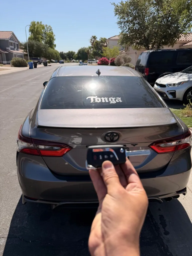 Toyota remote key shown with the customer's sedan after an all-keys-lost job